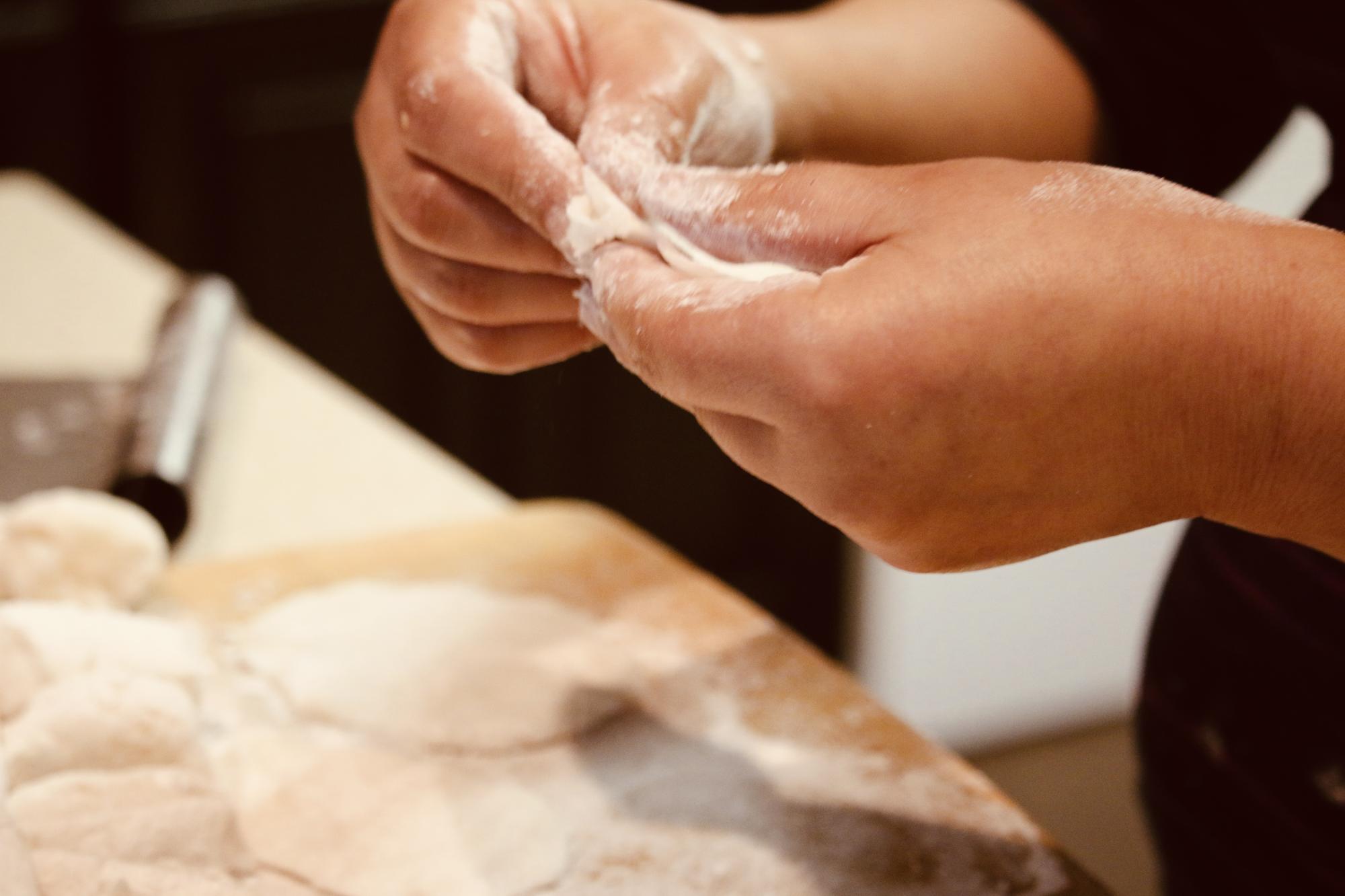 Hands kneading dough in studio